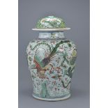 A large Chinese 17th century famille verte dragon and phoenix jar with later cover. Total 38cm tall