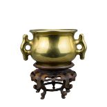 A quality Chinese 18th century polished bronze censer with twin tabbed loop handles and raised six C