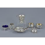 A group of seven English Sterling silver condiments. Including salt, mustard pot, pots and white met