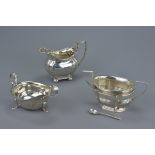 Three English Sterling silver Victorian and later milk jug, sauce-boat and twin-handled sugar bowl,