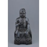 A Chinese 19th century bronze figure of the 'God of Wealth' holding an Ingot with inscription to bac