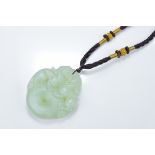 A Chinese carved jade Bi disc pendant surmounted with mythical beasts. 5cm length