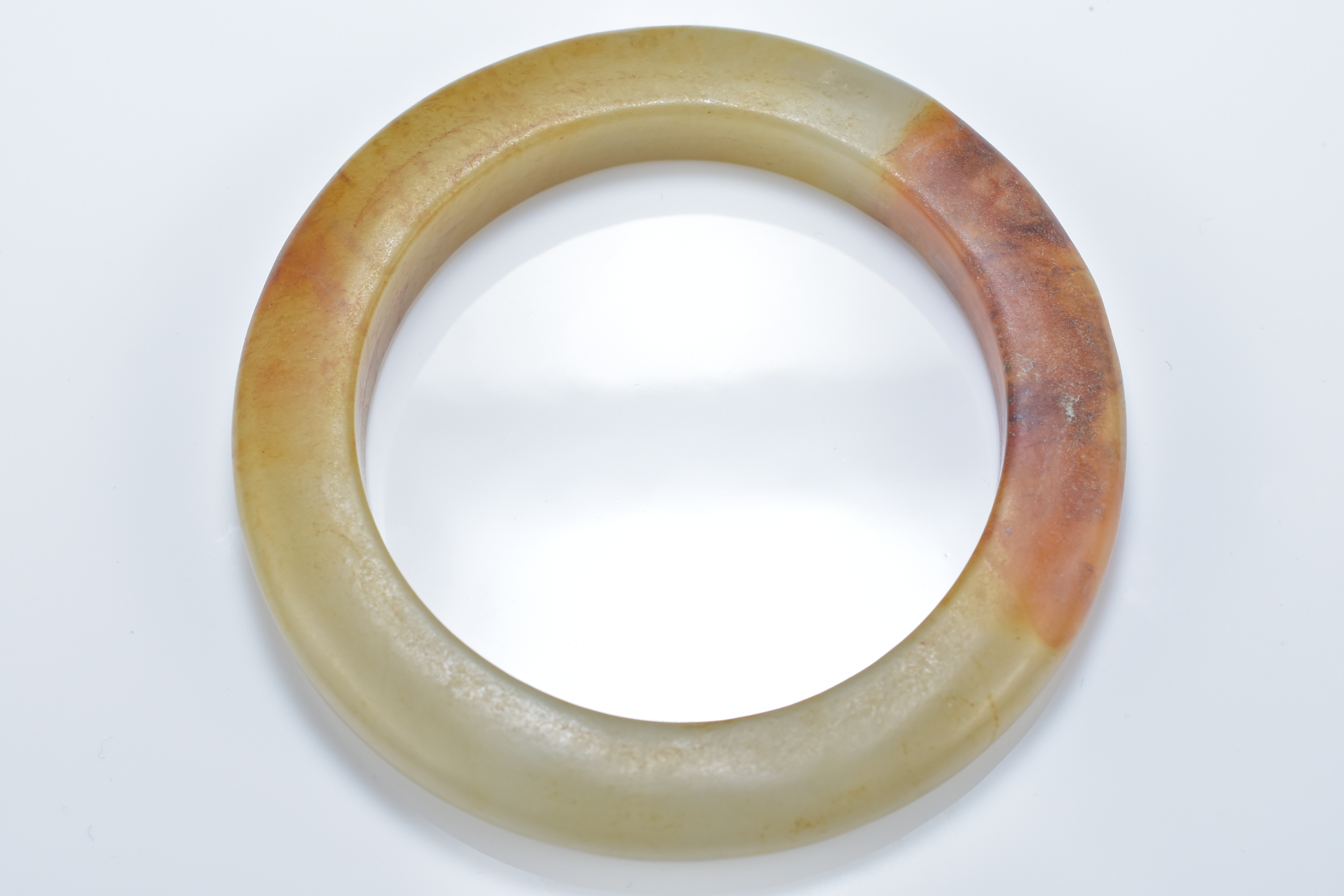 Two Chinese celadon and brown jade bangles. 8.5cm diameter. Inner diameter 6cm. - Image 3 of 4