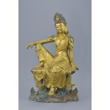 A Chinese gilt bronze figure of Guanyin seated on a separate base with figure of a turtle. Total hei