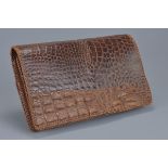 A vintage crocodile leather clutch bag in very good condition with interior zip and attached mirror.