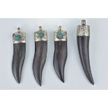 Four carved horn pendants with white metal mounts with turquoise coloured stone inserts. 7.5cm - 8.5