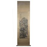 A Chinese watercolour painting on paper in scroll with wooden handles of a mountain scene with one r