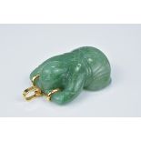 A vintage green jade pendant in the form of a Chinese boy lying on his front with 14ct gold clasp st