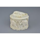 An early 20th century carved African ivory box and cover carved with elephants. 11Cm x 9.5cm
