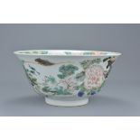 A Chinese 18th century Kangxi period porcelain bowl decorated with figure and floral scene with insc