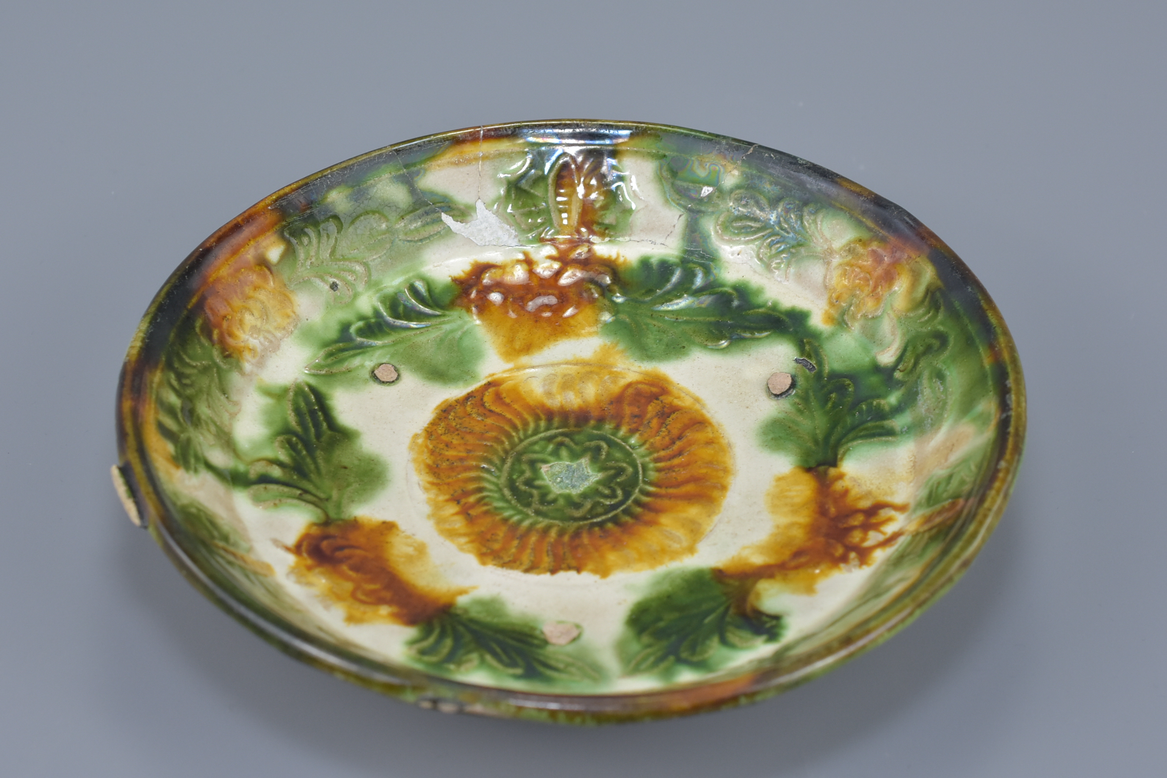 A Chinese Liao dynasty Sancai glazed shallow dish with molded floral decoration. 17cm diameter - Image 4 of 4