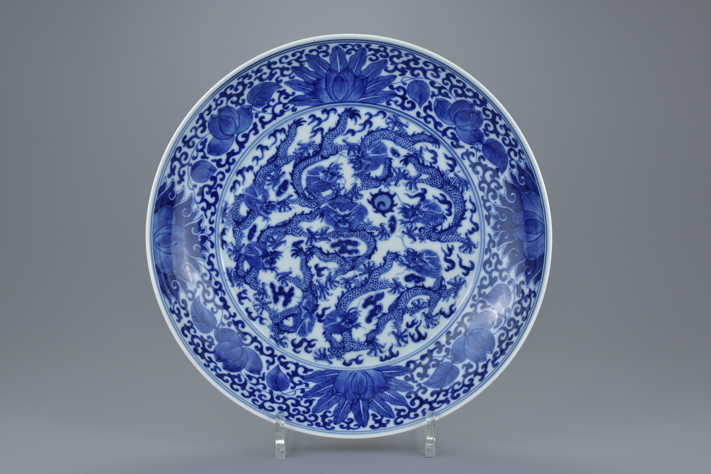 A Chinese late 19th century blue and white porcelain nine dragon dish. Mark and period of GuangXu (1