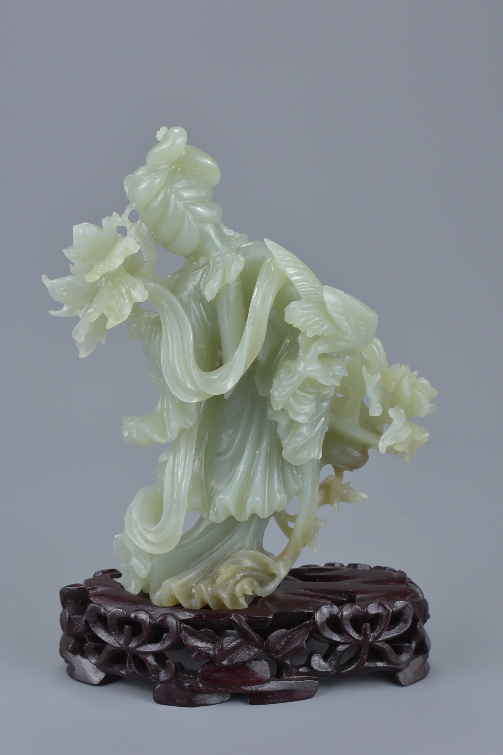 A Chinese jade figure of a Goddess holding flowers on a carved wooden stand together with a small re - Image 3 of 5