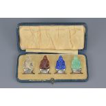 A set of four early 20th century coloured stone and silver hallmarked menu holders in ordinal box by