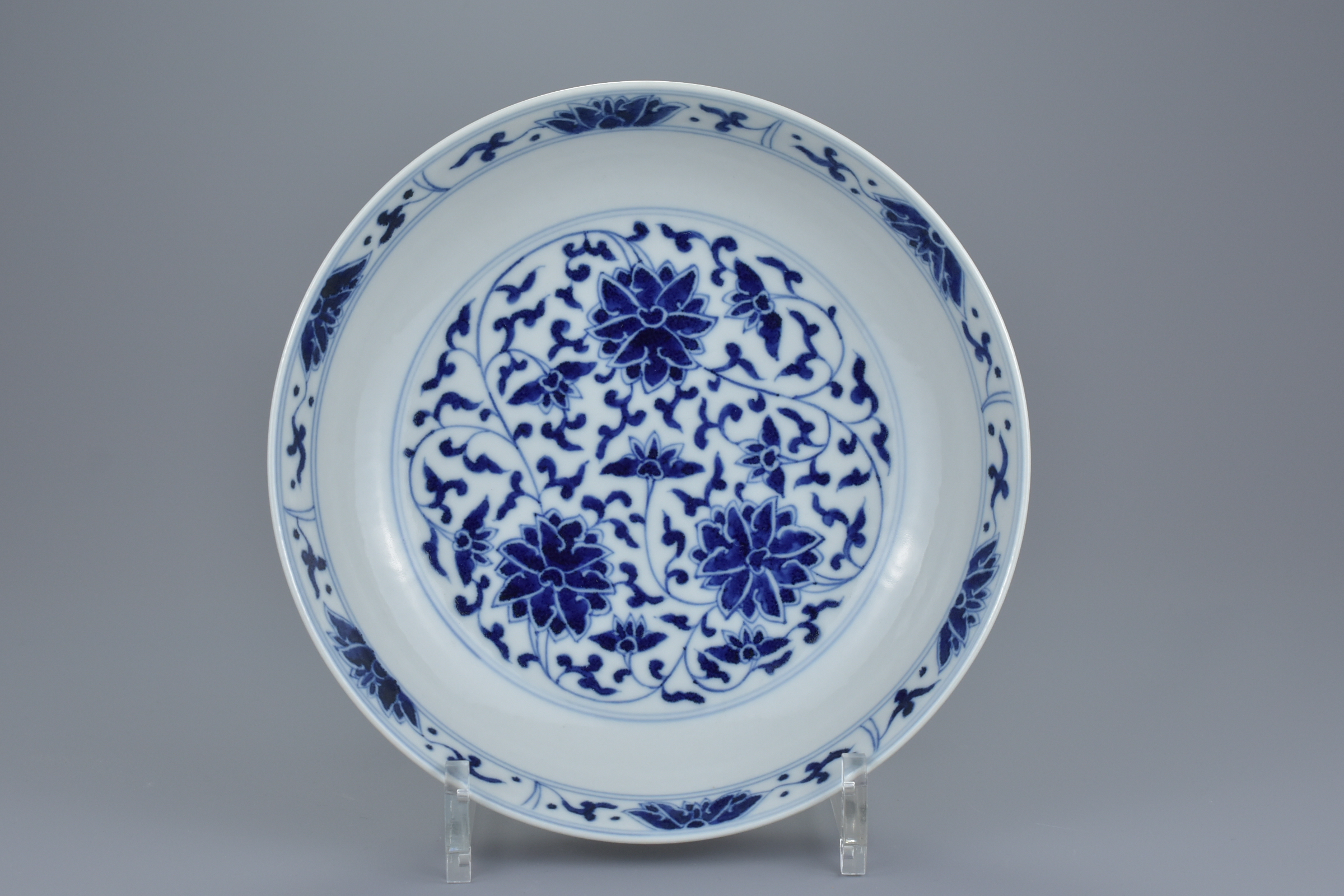 A Chinese late 19th century blue and white porcelain dish with floral lotus, chrysanthemum and peony