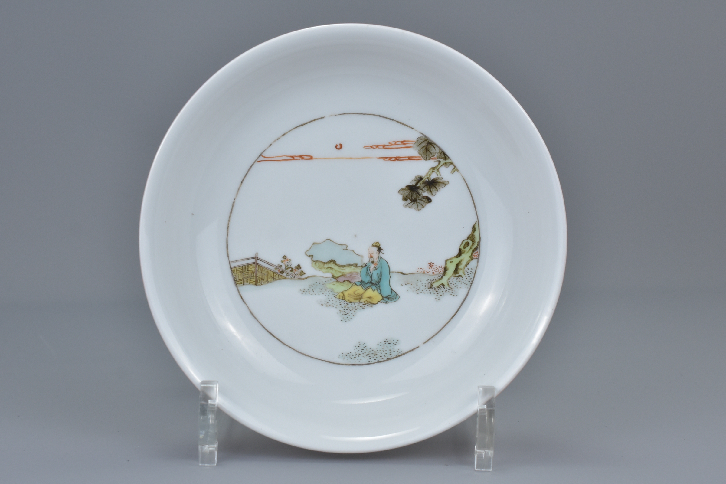 A Chinese 18/19th Famille Rose porcelain dish. Interior painted with a seated Scholar figure, coral