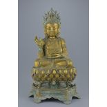A large Chinese gilt bronze figure of Guanyin seated in padmasana on separate lotus bronze stand 53c