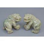 A pair of 19th century carved jadeite lions possibly Asian with ruby stone inserts in the eyes. 9Cm