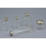 Five Victorian cut glass and silver capped bottles and hair pin bottle. (5)