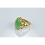 A Chinese high CT gold ring with jadeite cabochon. Chinese characters to inside of ring. Ring size L