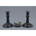 A pair of ebony wood candle sticks with silver mounts. London 1922 P&B. Together with a porcelain bo