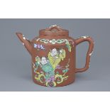 A Chinese Yixing teapot with enamel decoration of figures and blossoms. 15Cm x 18cm