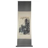 A Chinese watercolour painting on paper in scroll with wooden handles of a mountain scene with one r