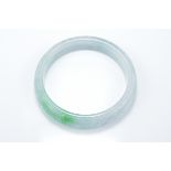 A Chinese carved jadeite bangle in pale white and green tone. Carved with Lingzhi. 5.75cm interior d