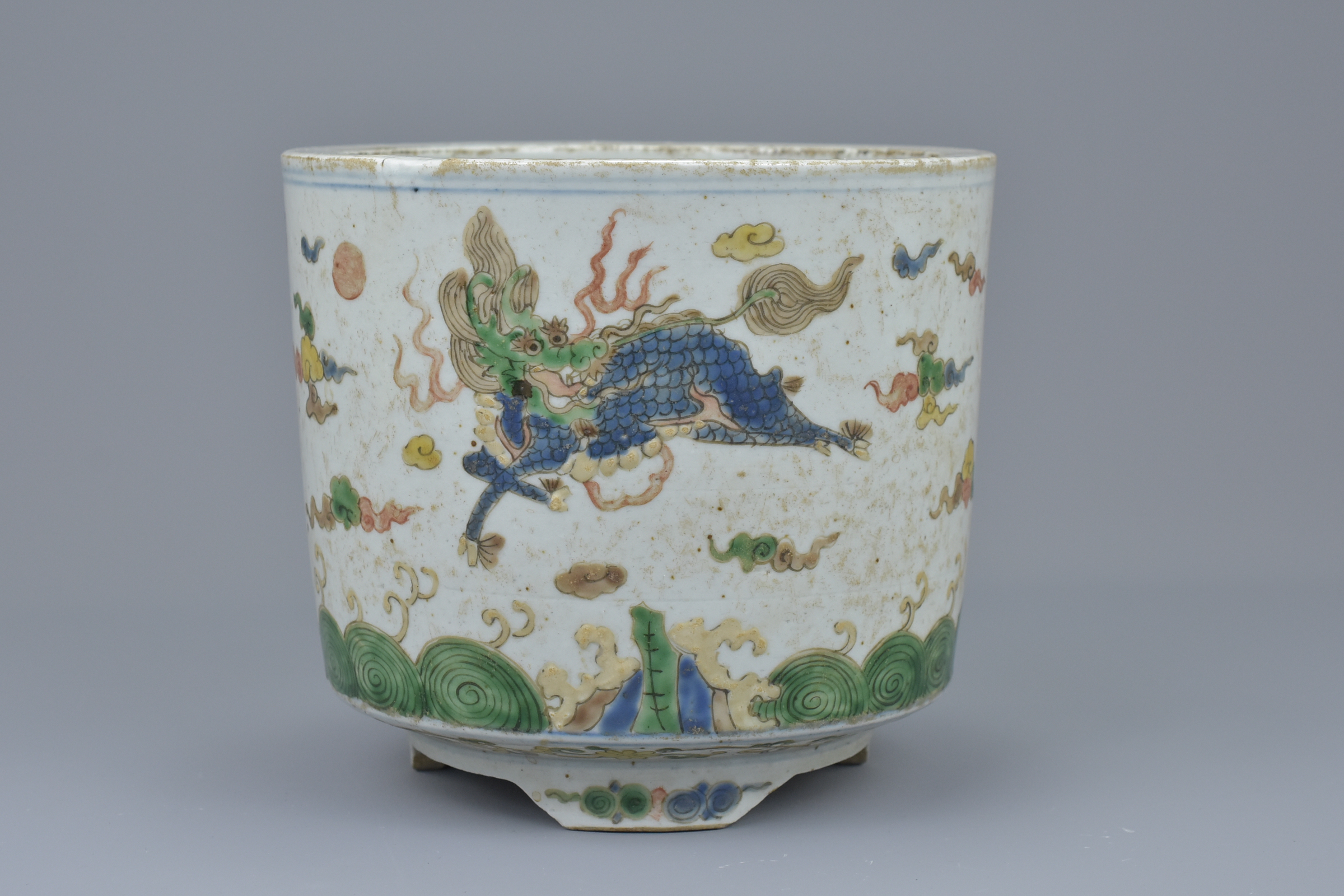 A Chinese 18/19th century doucai porcelain tripod censer with qilin, dragon and horse. 15.5cm diam x