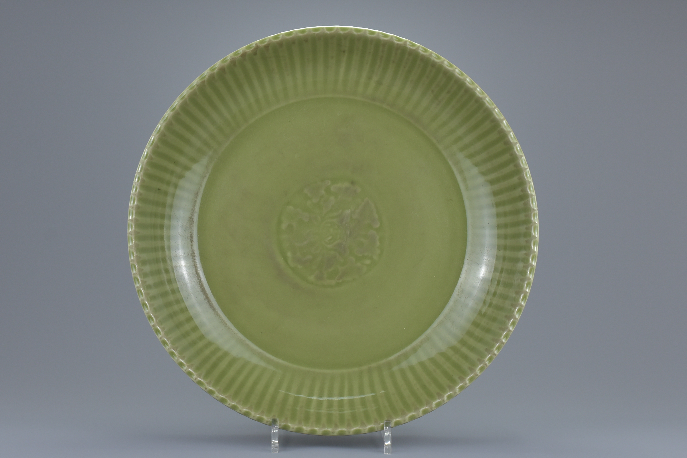 A large Chinese Ming dynasty or later celadon porcelain dish. 38cm diameter