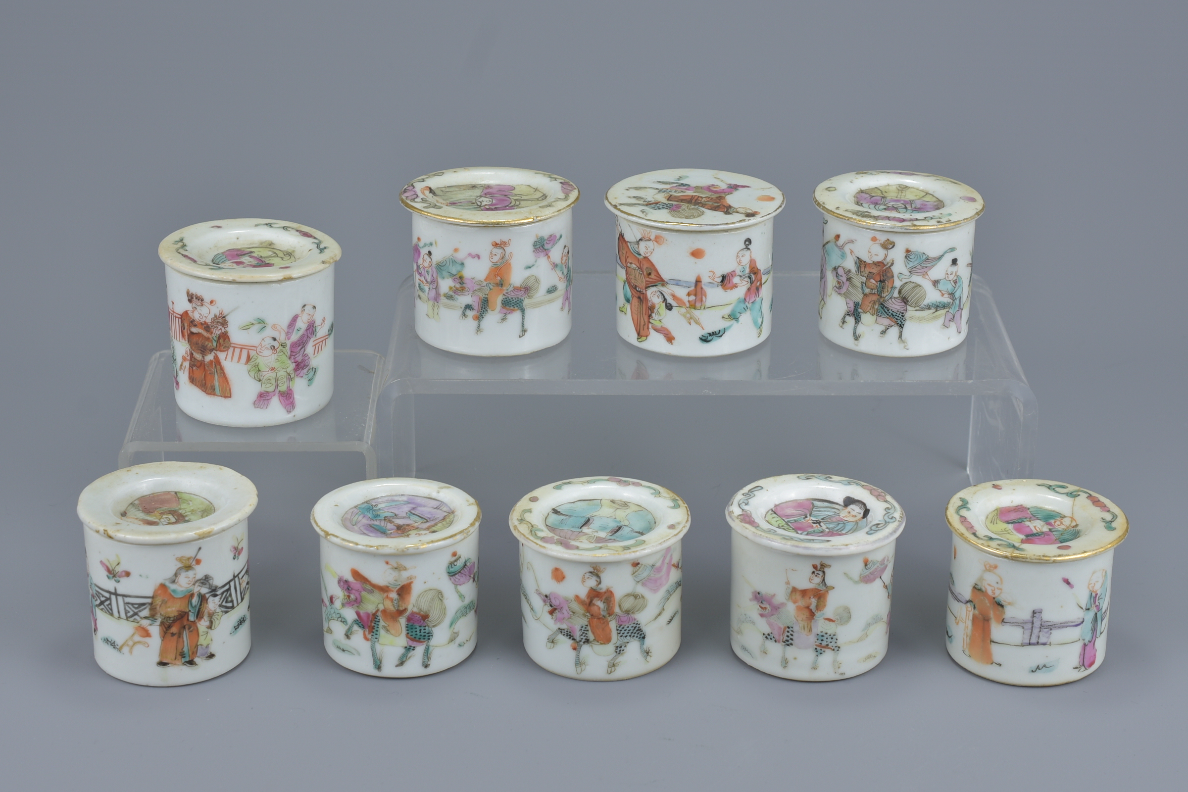 A group of nine Chinese 19th Century Famille Rose porcelain pots and covers