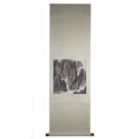 A Chinese watercolour and ink painting on paper in scroll with wooden handles of a mountain scene wi