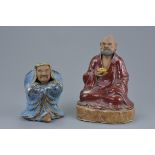 Two Chinese early 20th century Shiwan pottery figures of Immortals. The larger with a markers mark t