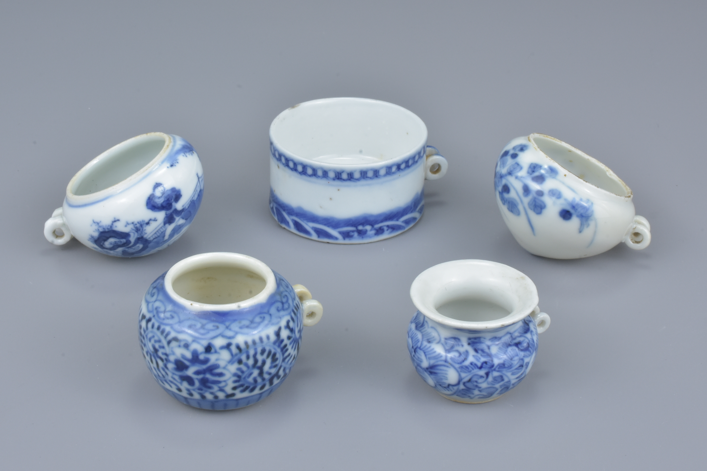 A group of five Chinese 19th Century blue and white porcelain bird feeders