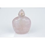 A Chinese 19th century carved pink quartz snuff bottle and stopper carved in relief with a bird sitt