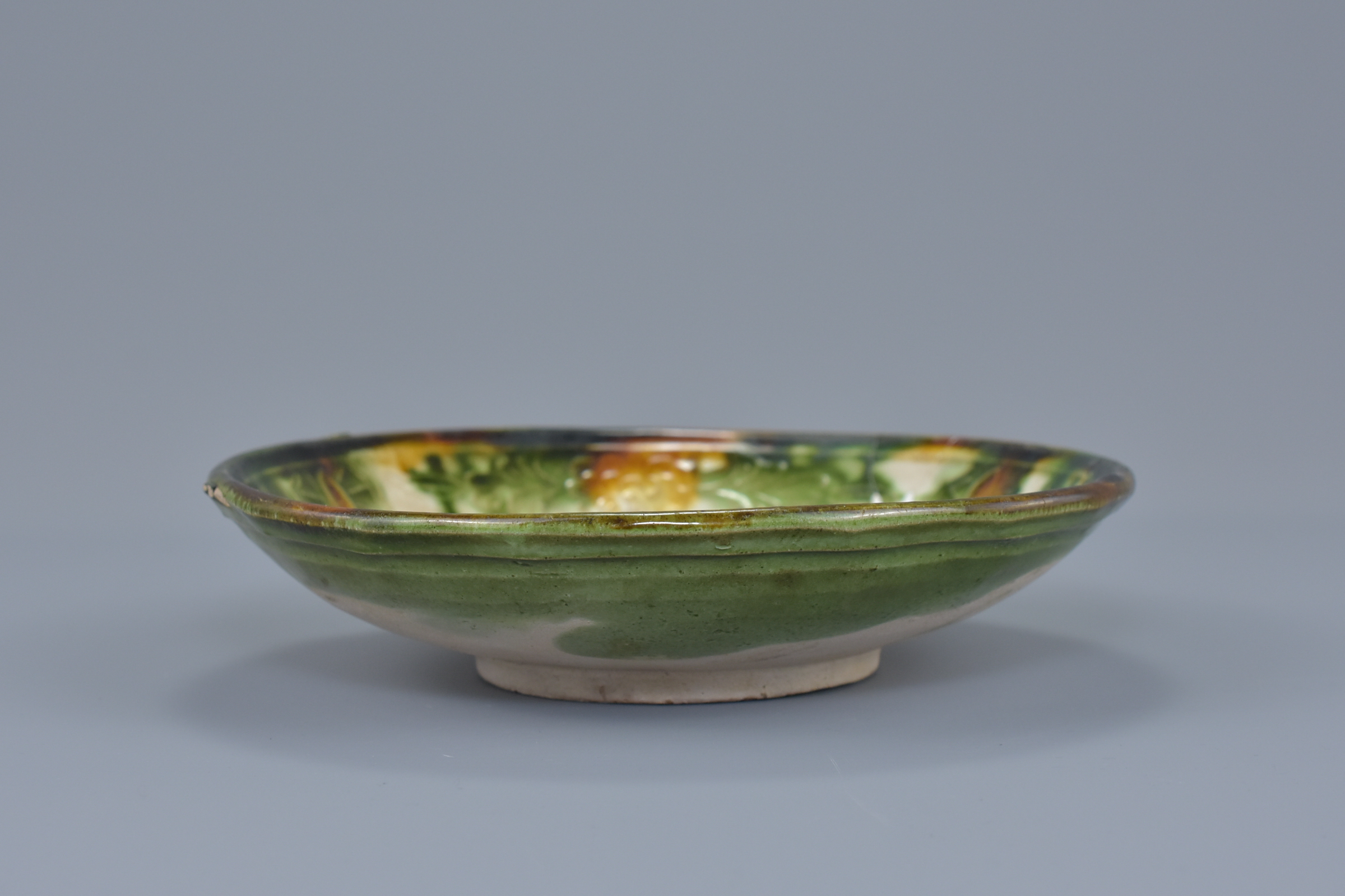 A Chinese Liao dynasty Sancai glazed shallow dish with molded floral decoration. 17cm diameter - Image 3 of 4