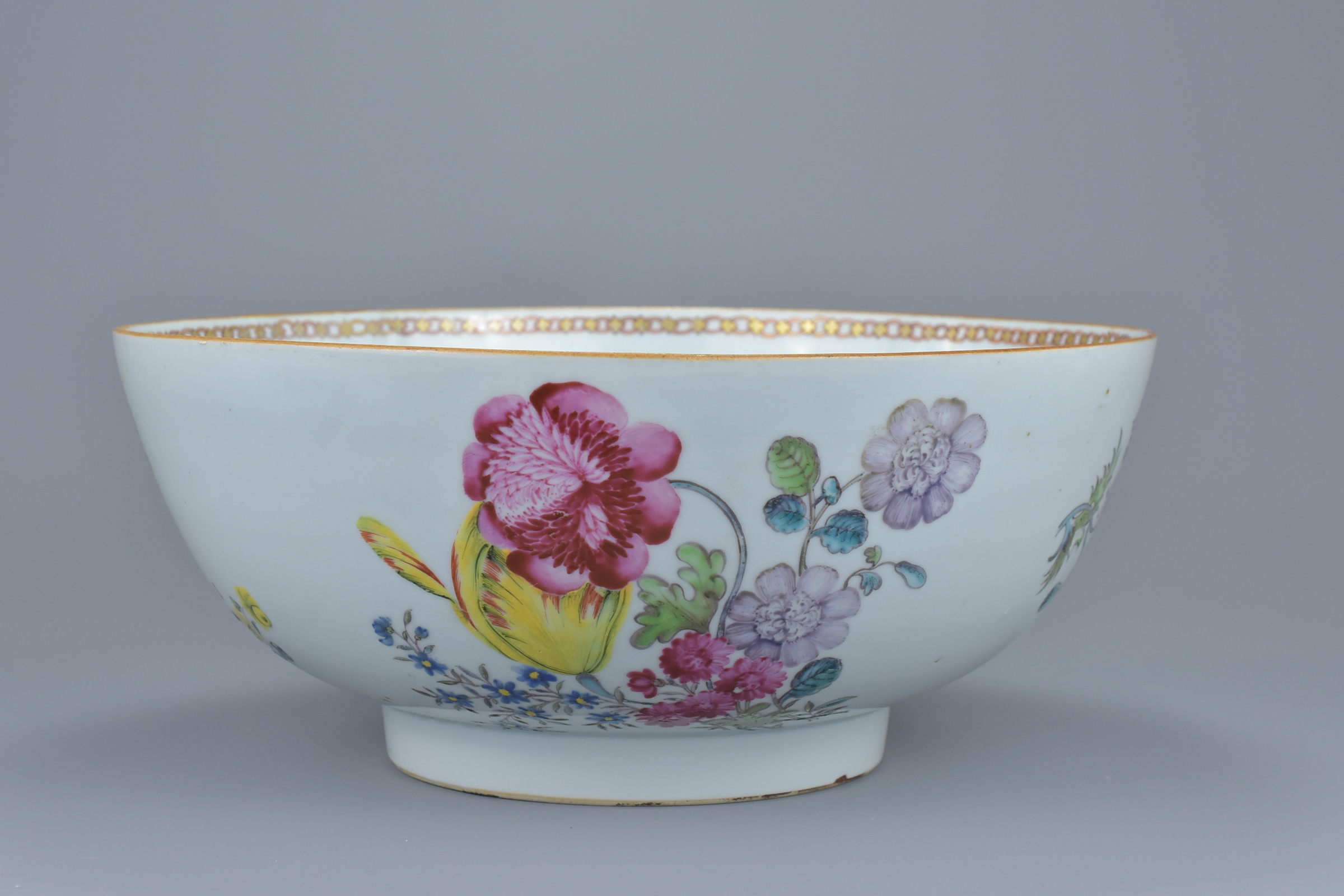 A large Chinese 18th century famille rose porcelain punch bowl decorated with various flowers and br