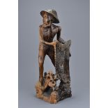 A Southeast Asian Hardwood Figure of a Fisherman