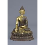 A Tibetan gilt bronze figure of a seated Buddha