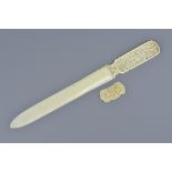 A Chinese early 20th C. carved ivory letter opener