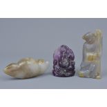 A carved amethyst figure of Ganesh together with two carved agate figures