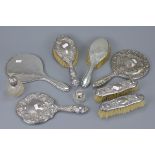 A group of antique silver hand mirrors and brushes