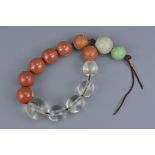 A string of rock crystal, jade and stone beads.