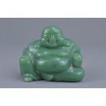 A Chinese carved green jade figure of a laughing B