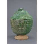 A Chinese Song / Yuan Dynasty green glazed Buddhist jar and cover