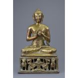 A South East Asian gilt copper figure of a seated Buddha