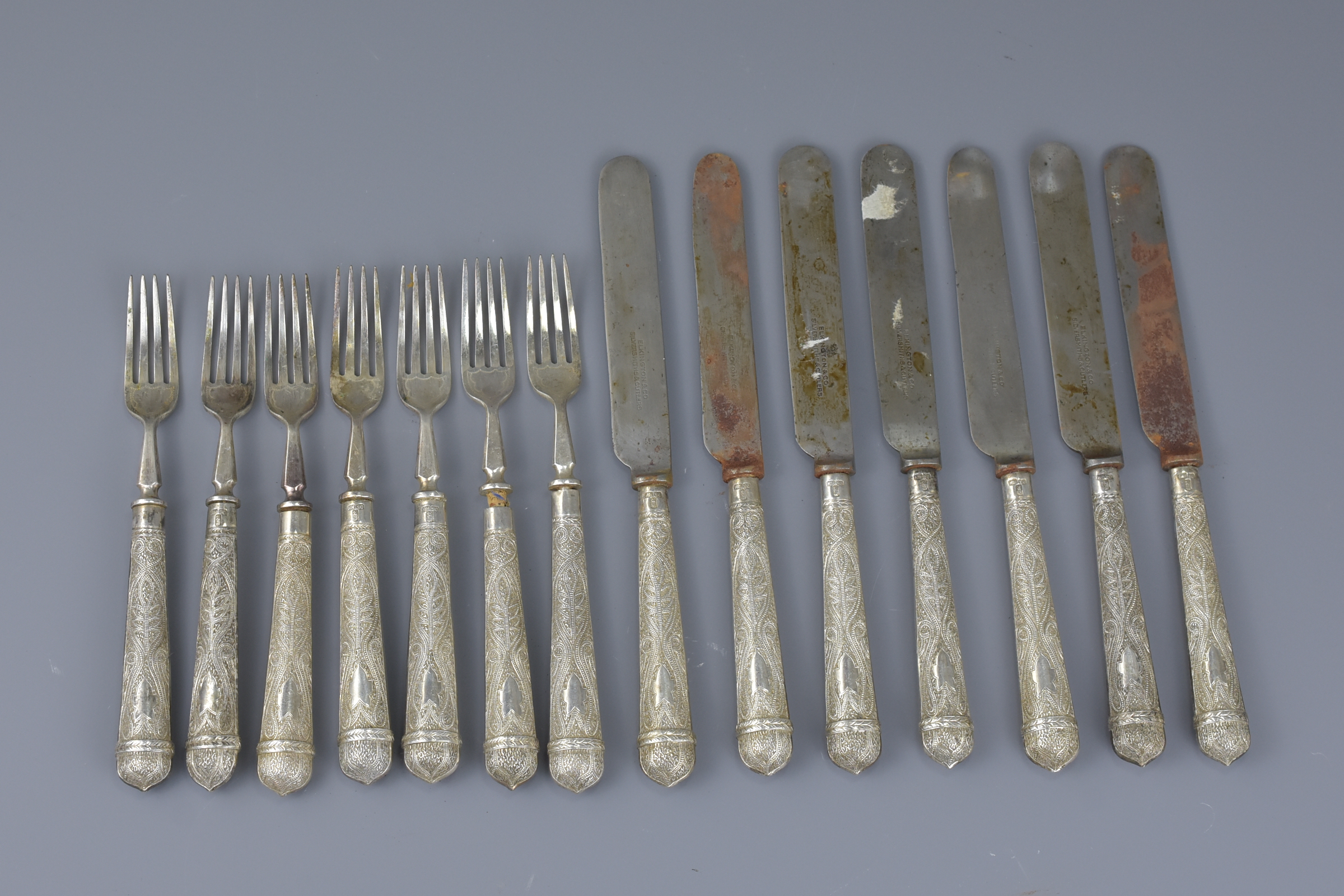 A set of fourteen Chinese silver handled knives and forks stamped WH 90