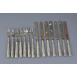 A set of fourteen Chinese silver handled knives and forks stamped WH 90