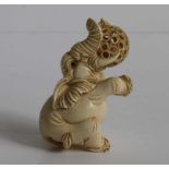 Carved ivory netsuke of an elephant holding a puzzle ball with loose carved inner ball Japan,