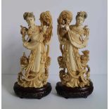 Ivory figures by He Xiangu with flowers symmetrically carved, China Republic period H 28,5 cm + 4,5